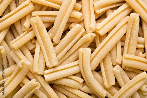 Artisan italian durum wheat pasta, raw casarecce pasta, top view.