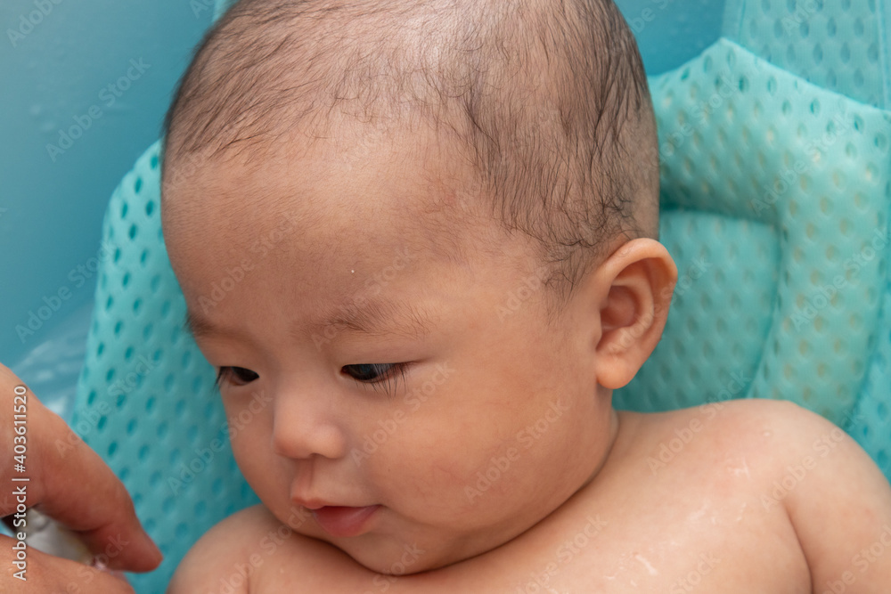 Portrait image of happy Asian Chinese baby boy being bathed Portrait image of happy Asian Chinese baby boy being bathed