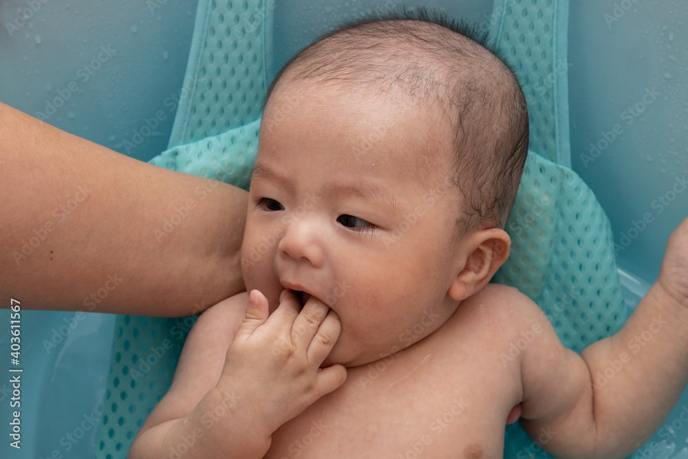 Portrait image of happy Asian Chinese baby boy being bathed Portrait image of happy Asian Chinese baby boy being bathed
