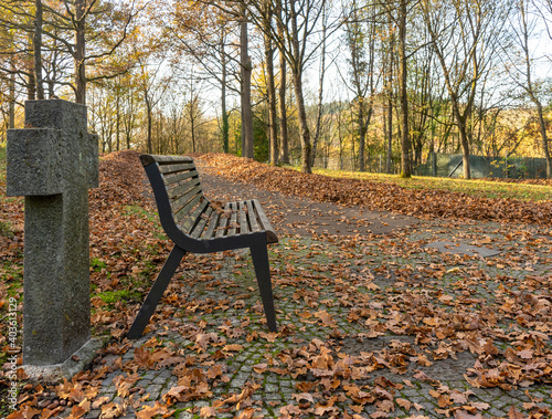 bench in a cemetery at autumn time