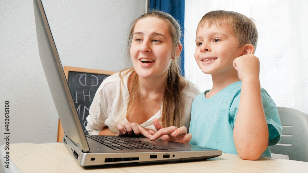 Happy smiling mother with little son using laptop and looking on computer screen. Happy smiling mother with little son using laptop and looking on computer screen.
