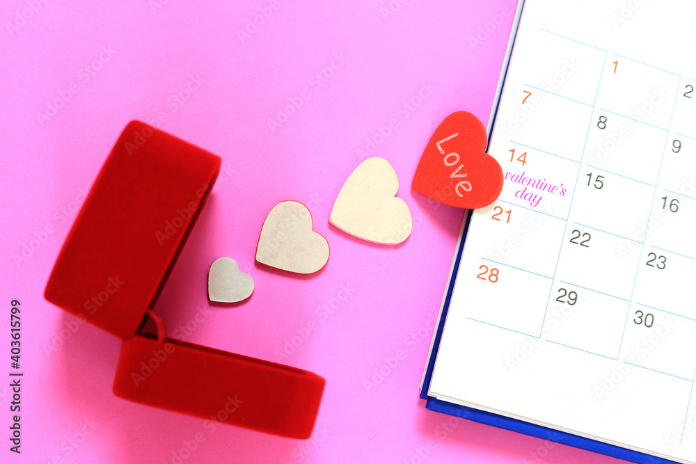 Valentines day red heart and red gift jewelry box with calendar on 14 february date background , valentine's day concept Valentines day red heart and red gift jewelry box with calendar on 14 february date background , valentine's day concept