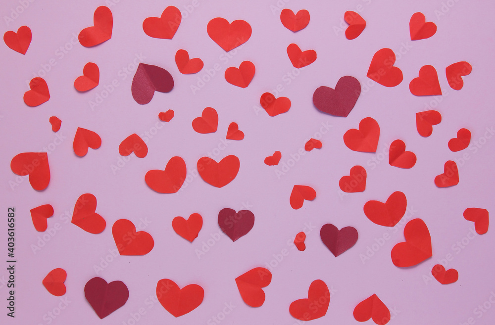 Lots of little red hearts on a pink background. Background for decor. Top view