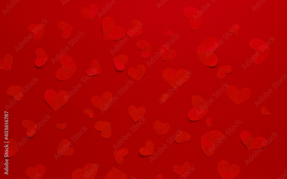 Many red hearts on a red background. Festive background. Background for design. Top view. St. Valentina.