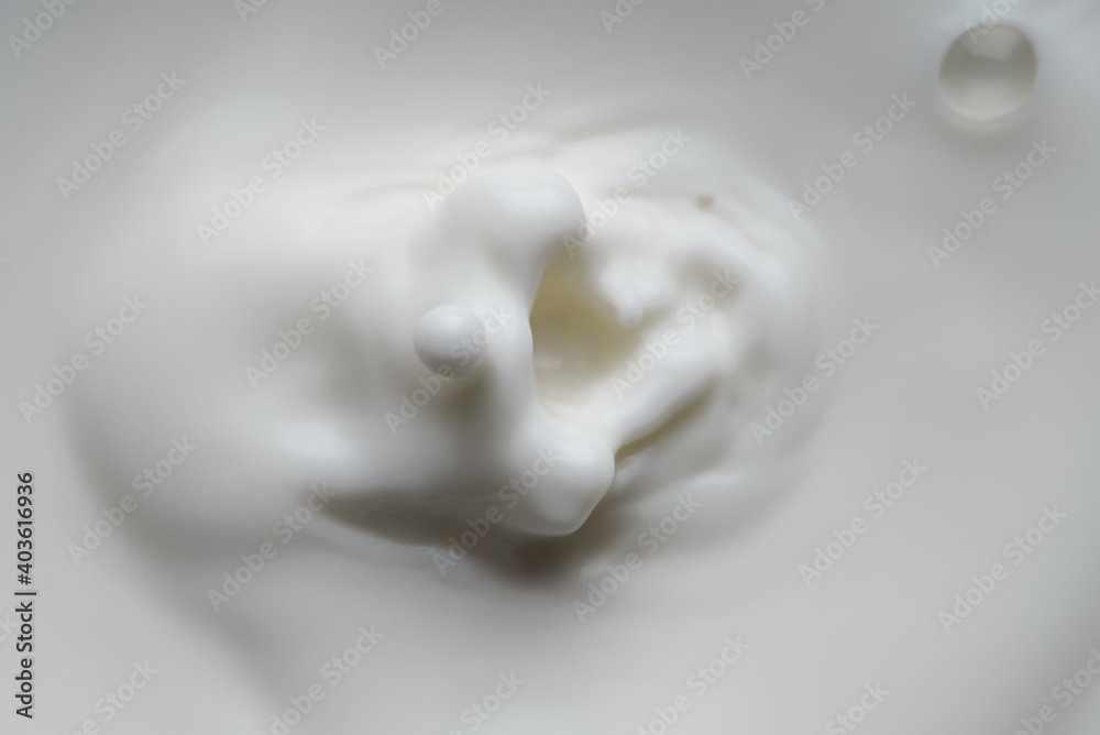 Milk or cream drop falls from the top.