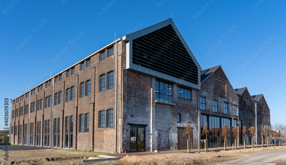 Dark brick facade of an old abandoned factory.