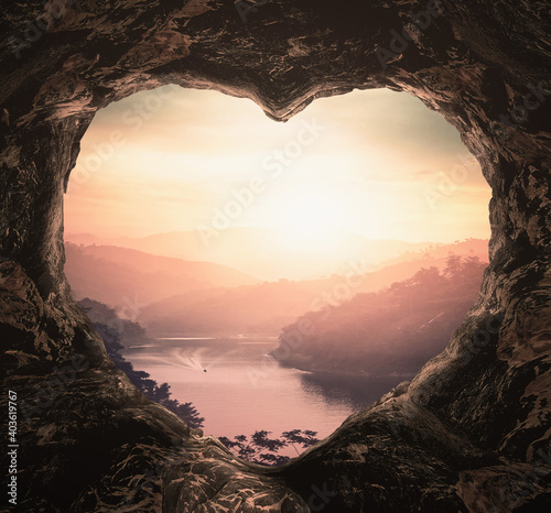 Photographie Heart shape of cave on river and mountains sunset background