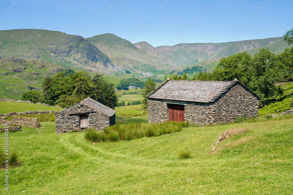 Two stone barns in the valley near Kentmere with the summits of Two stone barns in the valley near Kentmere with the summits of