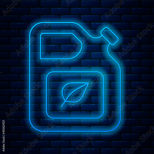 Glowing neon line Bio fuel canister icon isolated on brick wall background. Eco bio and barrel. Green environment and recycle. Vector.