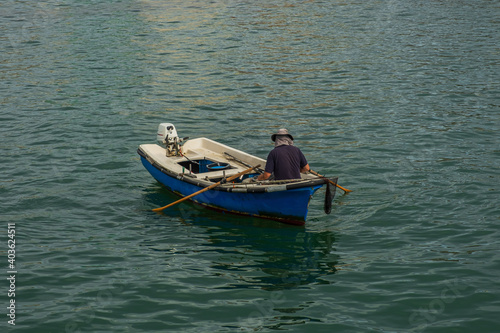 Fisherman in his small boat fishing in the sea