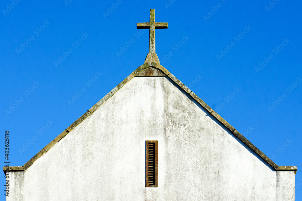 Rye, England - The white exterior of Rye Methodist Church, including a small window and cross, on a clear summer day.  Image has copy space.