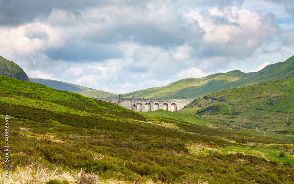 Fototapeta premium The dam wall and towers of Lochan na Lairige reservoir near Loch Tay in the Scottish Highlands, UK.