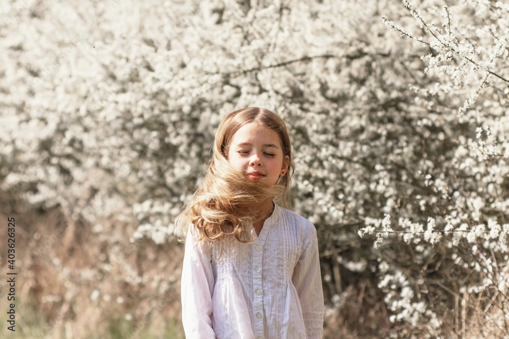 Spring portrait of beautiful young girl with blooming trees background. Spring time nature concept. Spring portrait of beautiful young girl with blooming trees background. Spring time nature concept.