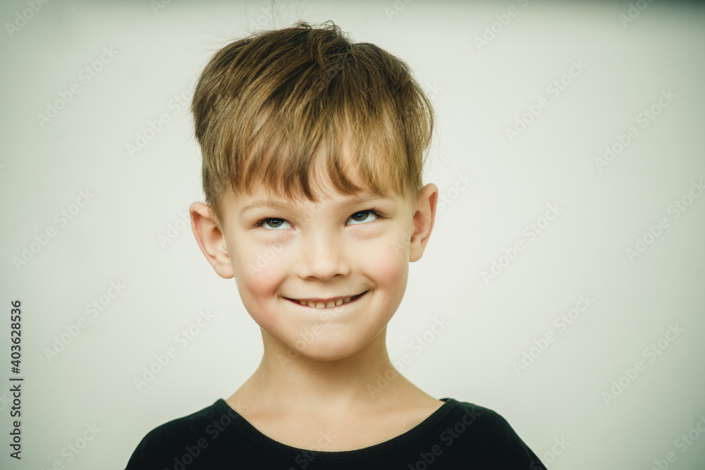 portrait of a surprised and cheerful boy on a white background portrait of a surprised and cheerful boy on a white background