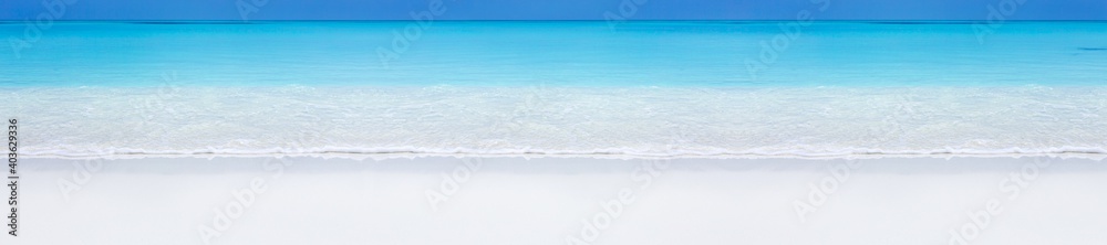 Tropical beach scene of azure crystal sea with soft waves. Long banner