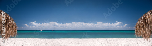 Tropical shore with thatched palapa. View on caribbean sea