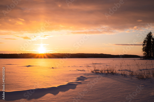 sunrise over frozen lake
