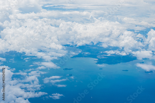 Wallpaper Mural Aerial view scene of an island in the big ocen which hiding under white fluffy clouds. Torontodigital.ca