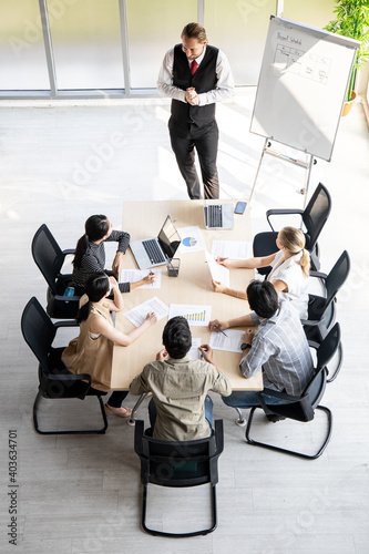 Top view of team meeting to analyze assignments.