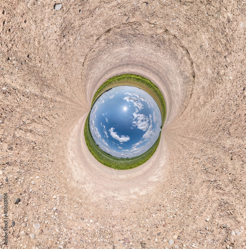 Blue little planet among white sand. Inversion of tiny planet transformation of spherical panorama 360 degrees. Spherical abstract aerial view. Curvature of space.