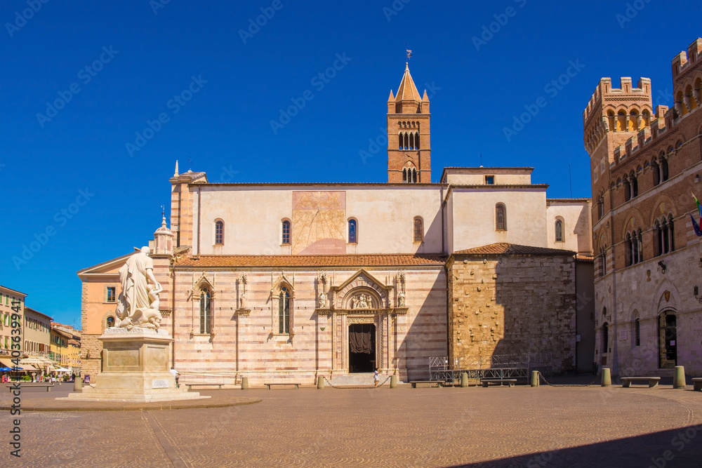The Romanesque Cattedrale di San Lorenzo, Saint Lawrence Cathedral, in Piazza Dante, Grosseto, Tuscany. On the right is Palazzo della Provincia, on the left Canapone Monument, Monumento a Leopoldo II 