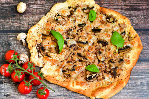  Home made Tuna fish italian style pizza. Parmesan cheese, mozzarella , mushrooms,olives cherry tomatoes and ,fresh basil