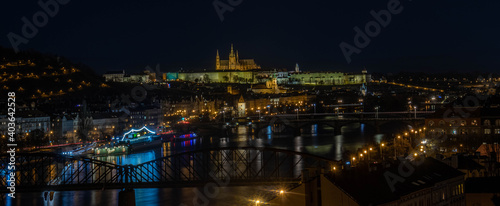 Night cityscape of Prague with reflections on a river. © Pavel