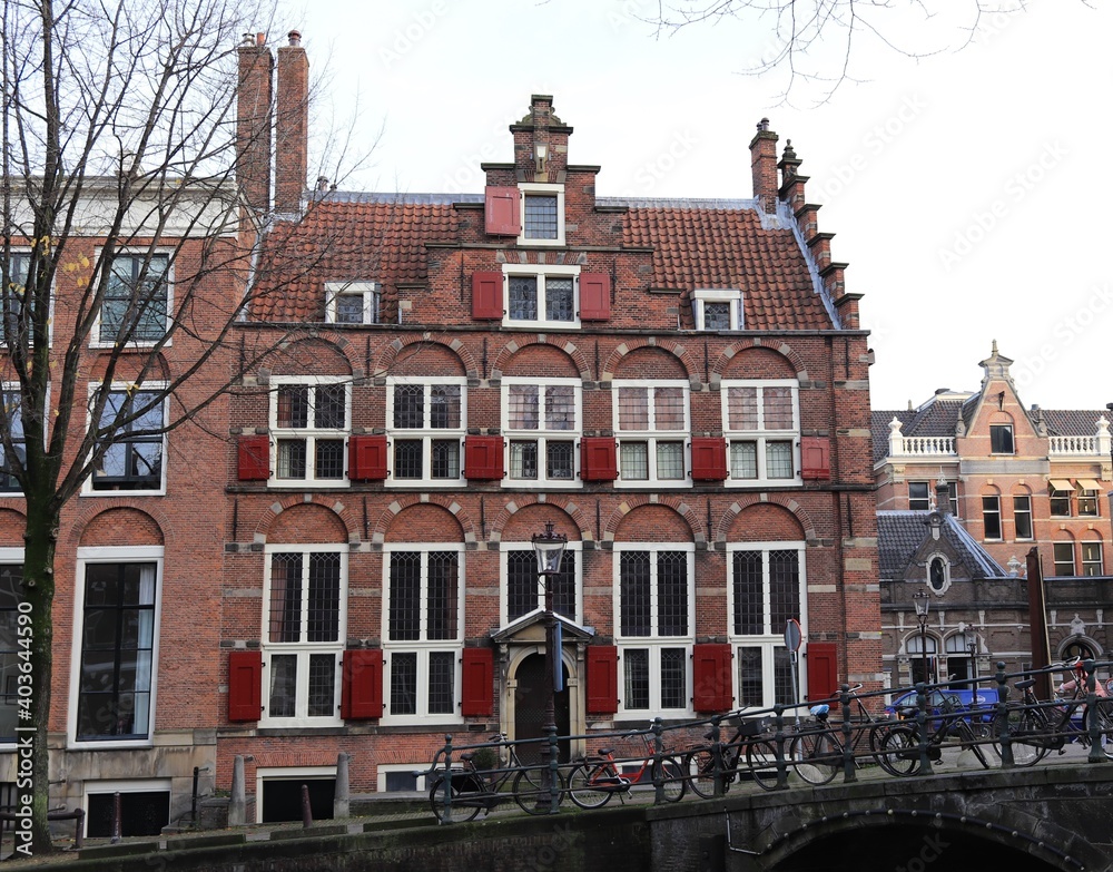 Traditional Amsterdam Canal Building with Red Shutters in Amsterdam