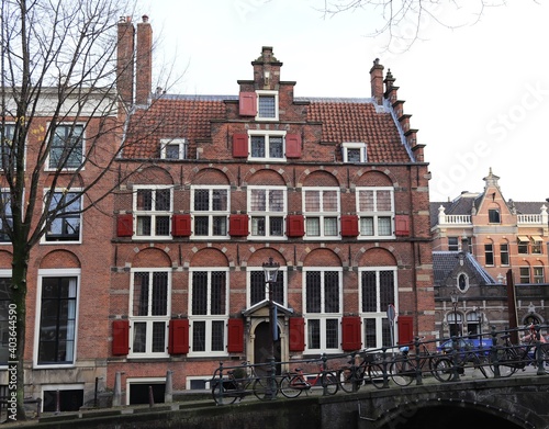 Traditional Amsterdam Canal Building with Red Shutters in Amsterdam