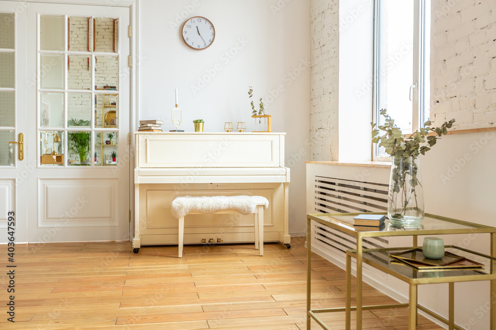 the interior of the study in the style of a loft. Brick wall. wooden flooring. large bright room with a seating area. sofa and piano the interior of the study in the style of a loft. Brick wall. wooden flooring. large bright room with a seating area. sofa and piano