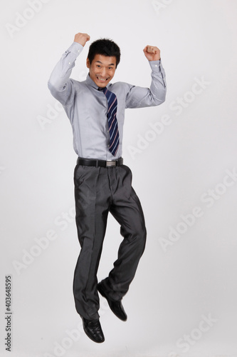 A business man jumping up in a shirt  © eastfenceimage
