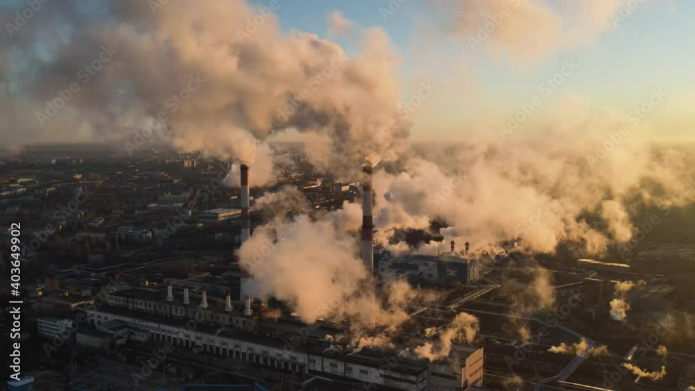 Aerial view smoke clouds from plant pipes on industrial area. Smoking chimney on plant industry city Aerial view smoke clouds from plant pipes on industrial area. Smoking chimney on plant industry city
