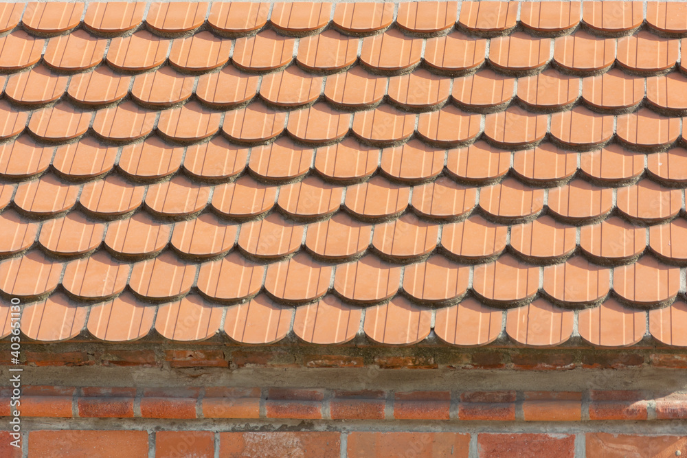 Old red clay tiles on roof close-up. Selective focus, vintage background