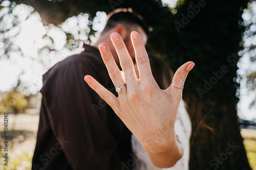 Engaged couples showing their engagement wedding ring