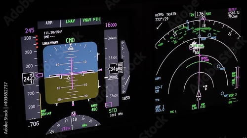 Flight instruments display of a modern passenger airplane flying at night. Actual cockpit footage. Aircraft is descending for landing.