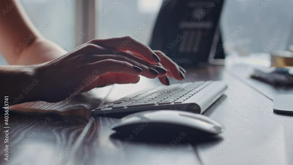 Beautiful hands of female bisiness worker typing text on desktop computer keyboard in a modern office. Co Wroking online job space