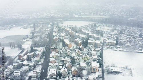 forward forward flight over a urban area in a middle of a snowy blizzard. photo