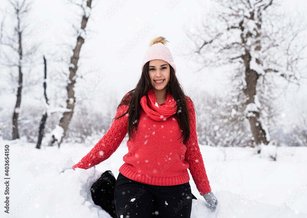 Portrait of a beautiful smiling young woman in wintertime outdoors Portrait of a beautiful smiling young woman in wintertime outdoors