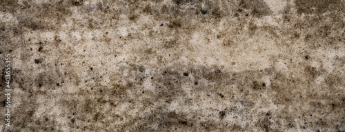 Badly stained texture on the snowy road 