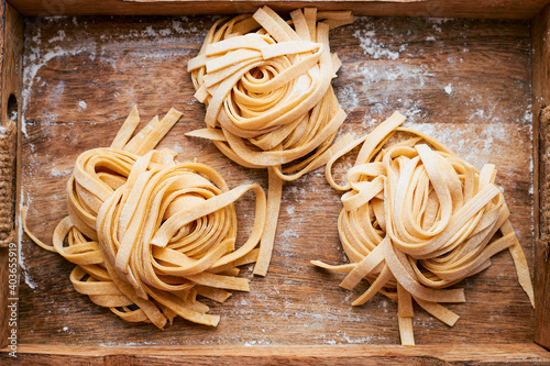 Fresh homemade fettuccine pasta in a wooden box