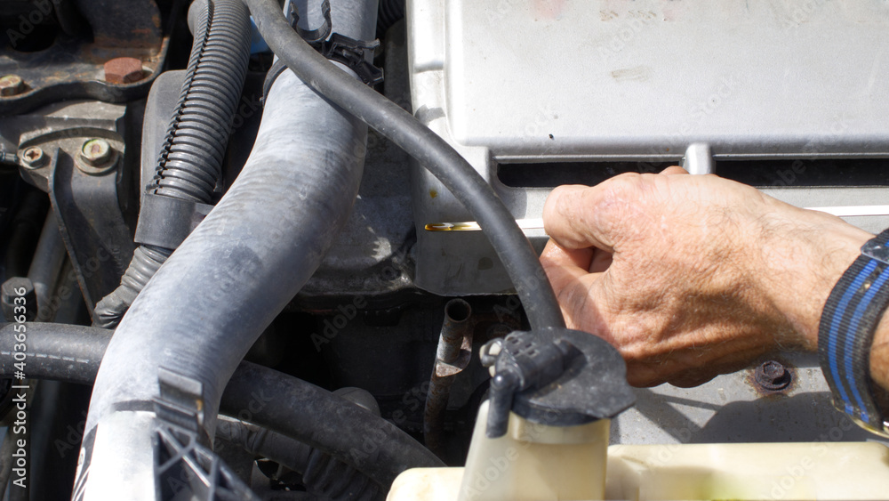 Obraz premium Mechanic Checking Oil Level