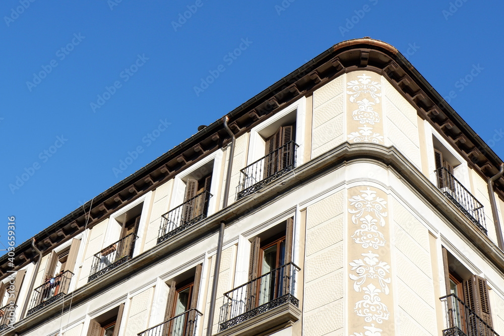 Corner of classical building with floral ornament in central district of Madrid, Spain.