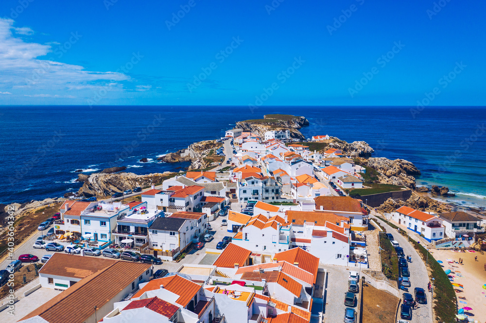 Aerial view of island Baleal naer Peniche on the shore of the ocean in west coast of Portugal. Baleal Portugal with incredible beach and surfers. Aerial view of Baleal, Portugal.