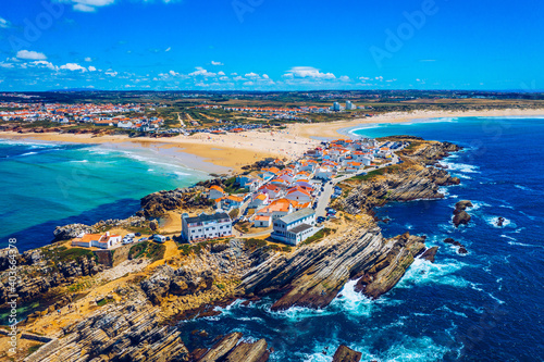 Aerial view of island Baleal naer Peniche on the shore of the ocean in west coast of Portugal. Baleal Portugal with incredible beach and surfers. Aerial view of Baleal, Portugal.