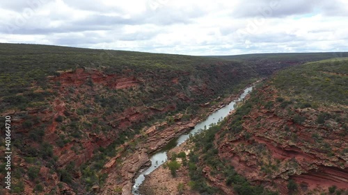 Revealing aerial shot of the Murchison River meandering through red sandstone gorges in Kalbarri National Park, Western Australia photo