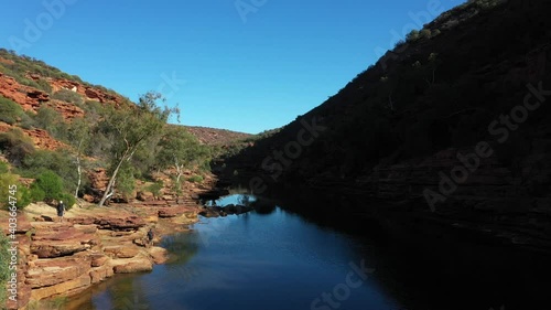 Two people hiking along the Murchison River near Four Ways in Kalbarri National Park, Western Australia photo