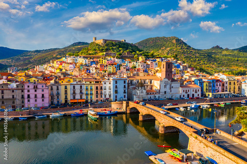 Aerial view of the beautiful village of Bosa with colored houses and a medieval castle. Bosa is located in the north-wesh of Sardinia, Italy. Aerial view of colorful houses in Bosa village, Sardegna. photo