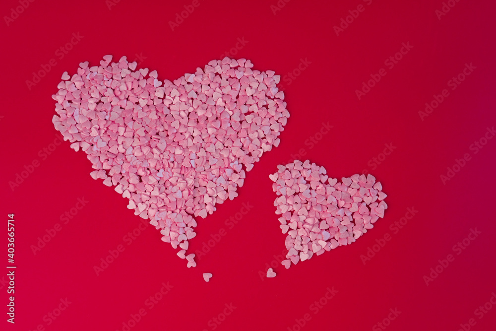 Two big hearts made of small hearts on red background. Love, wedding and happy valentine minimal concept. Copy space