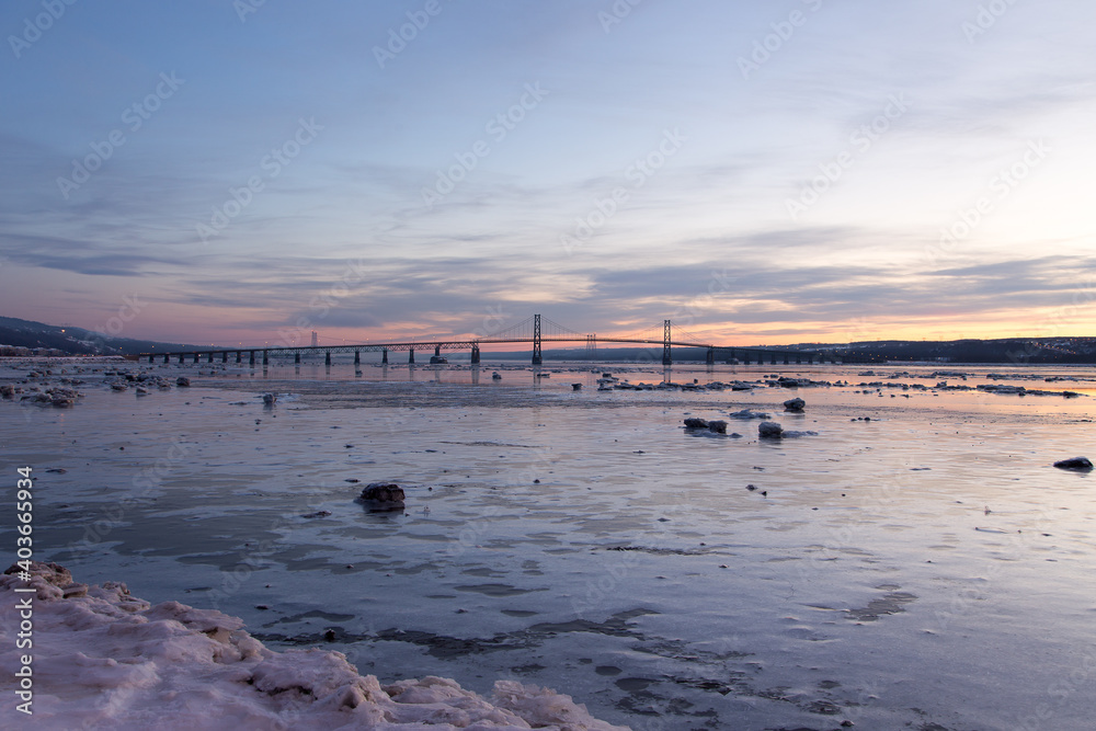 East view of the St. Lawrence River and the 1935 Island of Orleans Bridge seen during an blue hour dawn, Quebec City, Quebec, Canada