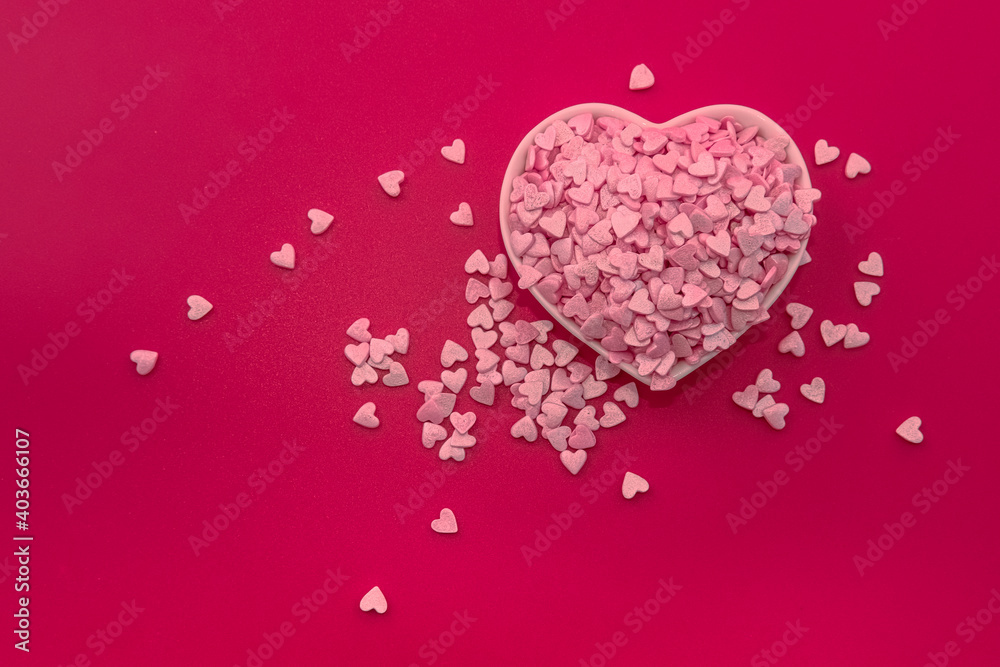 Happy Valentine's day minimal concept. Big white heart plate full of small pink hearts on red background